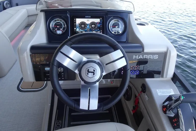 Slide: The Image of 2026 Harris Solstice 250 boat dashboard with steering wheel and digital display. - 18