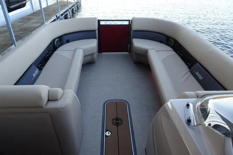 Slide: The Image of 2026 Harris Solstice 250 boat interior with beige seating and lake view. - 20