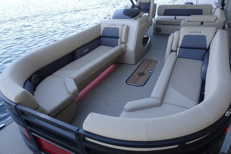 Slide: The Image of 2026 Harris Solstice 250 pontoon boat interior with luxurious seating on a calm lake. - 22