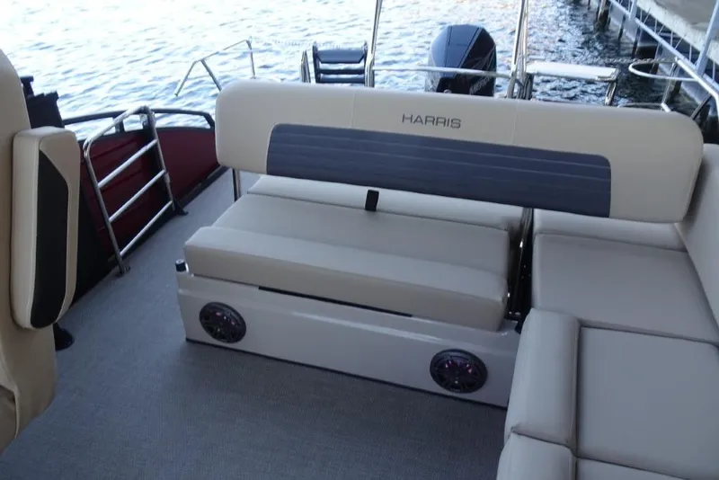 Slide: The Image of 2026 Harris Solstice 250 boat interior with beige seating and water view. - 24