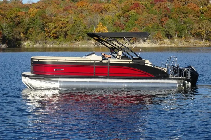 Slide: The Image of 2026 Harris Solstice 250 pontoon boat on a lake with autumn foliage background. - 7