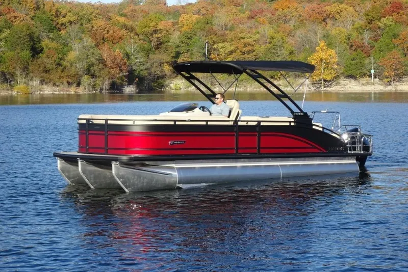 Slide: The Image of 2026 Harris Solstice 250 pontoon boat cruising on a scenic lake with autumn foliage. - 8