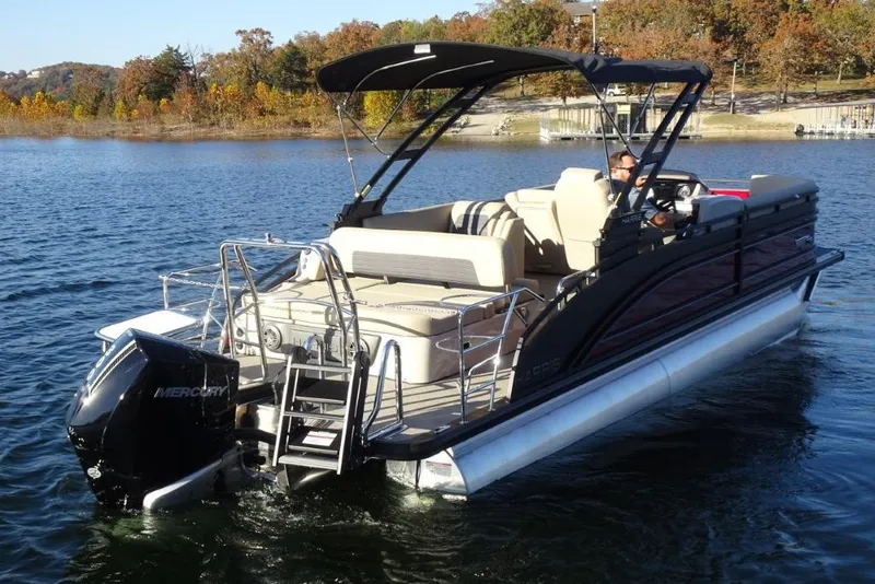 Slide: The Image of 2026 Harris Solstice 250 pontoon boat on a lake with scenic autumn backdrop. - 9