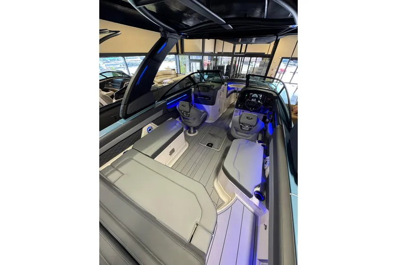 Slide: The Image of 2026 Chaparral 267 SSX boat interior with modern seating and blue ambient lighting. - 11