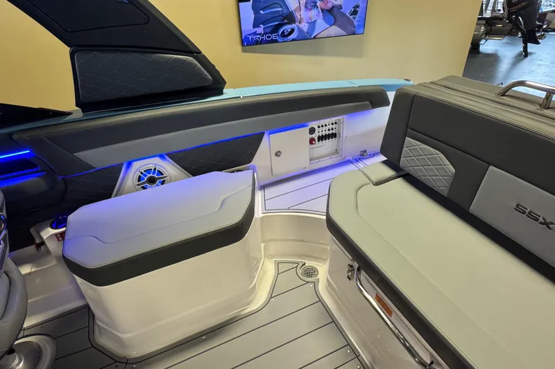 Slide: The Image of 2026 Chaparral 267 SSX boat interior with modern seating and blue LED lighting. - 12