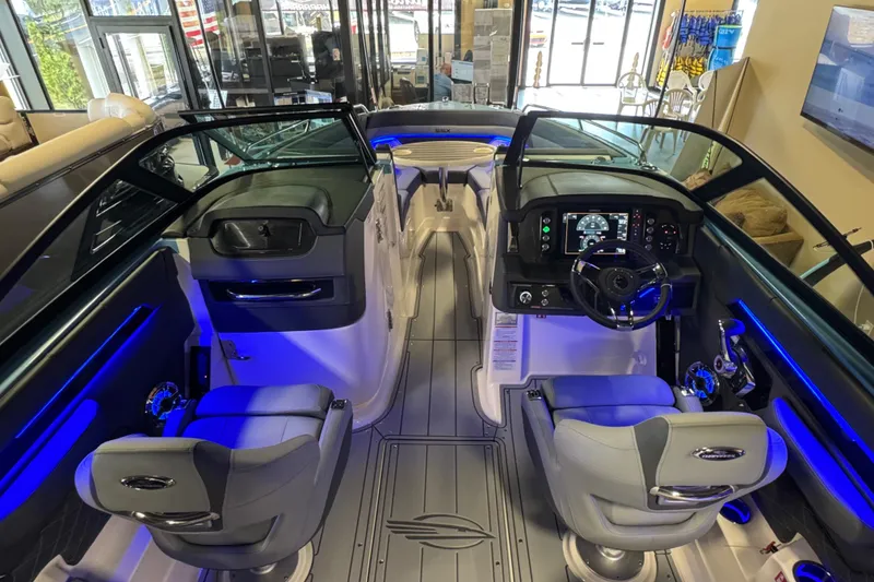 Slide: The Image of 2026 Chaparral 267 SSX boat interior with modern dashboard and seating. - 16