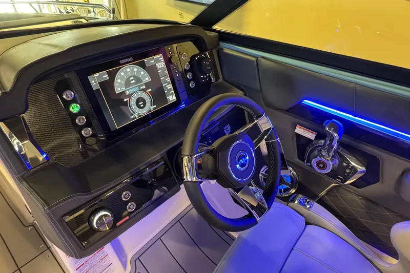 Slide: The Image of 2026 Chaparral 267 SSX dashboard with advanced controls and illuminated steering wheel. - 17