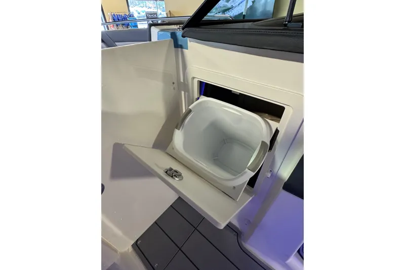 Slide: The Image of 2026 Chaparral 267 SSX boat interior with built-in storage compartment. - 19