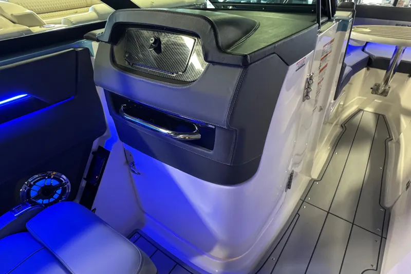 Slide: The Image of 2026 Chaparral 267 SSX boat interior with blue LED lighting and modern design. - 20