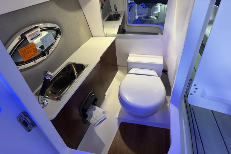 Slide: The Image of 2026 Chaparral 267 SSX boat interior bathroom with sink and toilet. - 21