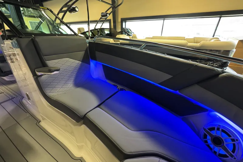 Slide: The Image of 2026 Chaparral 267 SSX boat interior with blue LED lighting and luxurious seating. - 28