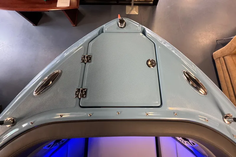 Slide: The Image of 2026 Chaparral 267 SSX boat bow with sleek design and storage compartment. - 30