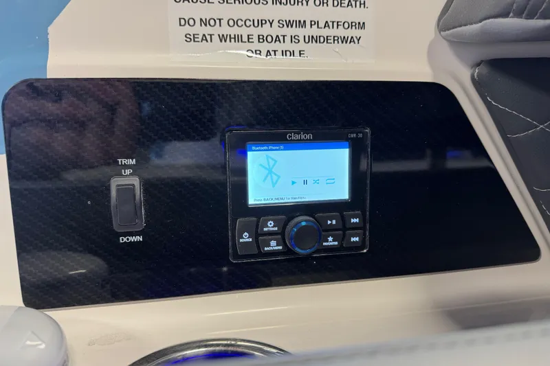 Slide: The Image of 2026 Chaparral 267 SSX boat dashboard with Clarion audio system and trim controls. - 7