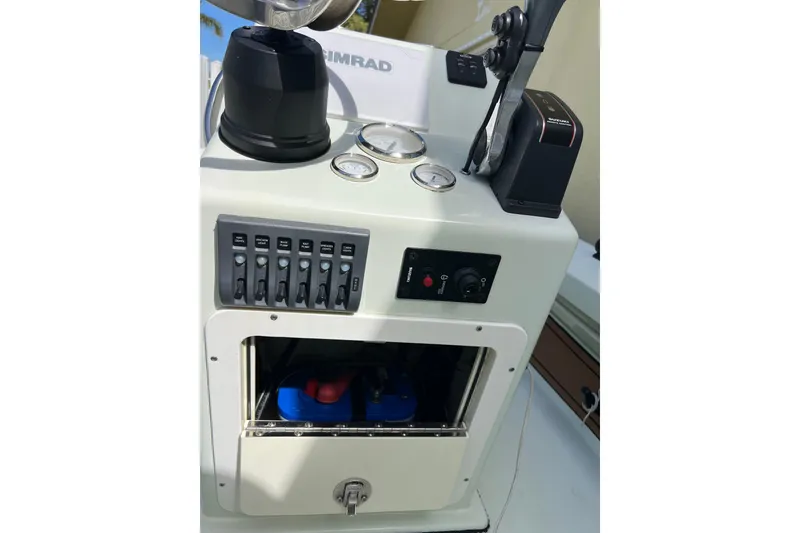 Slide: The Image of 2017 Beavertail Skiffs Mosquito 18 console with gauges, switches, and storage compartment. - 14