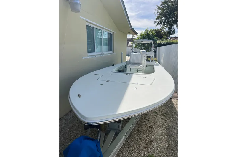Slide: The Image of 2017 Beavertail Skiffs Mosquito 18 boat parked beside a house. - 3