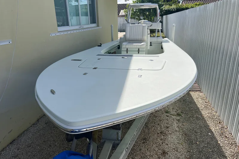 Slide: The Image of 2017 Beavertail Skiffs Mosquito 18 boat parked beside a house, showcasing sleek design. - 4