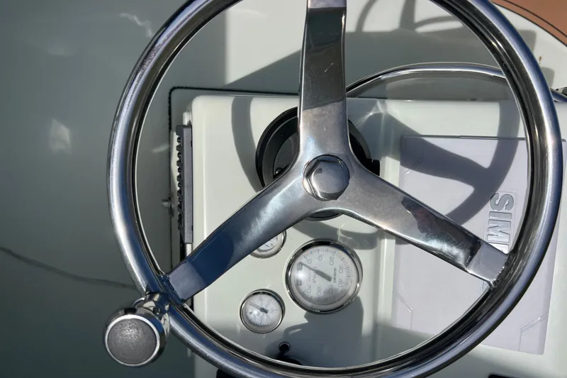 Slide: The Image of Steering wheel and gauges of a 2017 Beavertail Skiffs Mosquito 18 boat. - 7