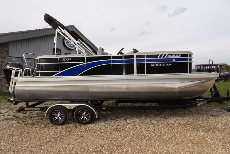 Slide: The Image of 2024 Bennington 22 SXS pontoon boat on trailer, side view. - 10