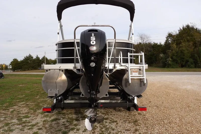 Slide: The Image of 2024 Bennington 22 SXS pontoon boat with powerful 150 HP outboard motor, rear view. - 13