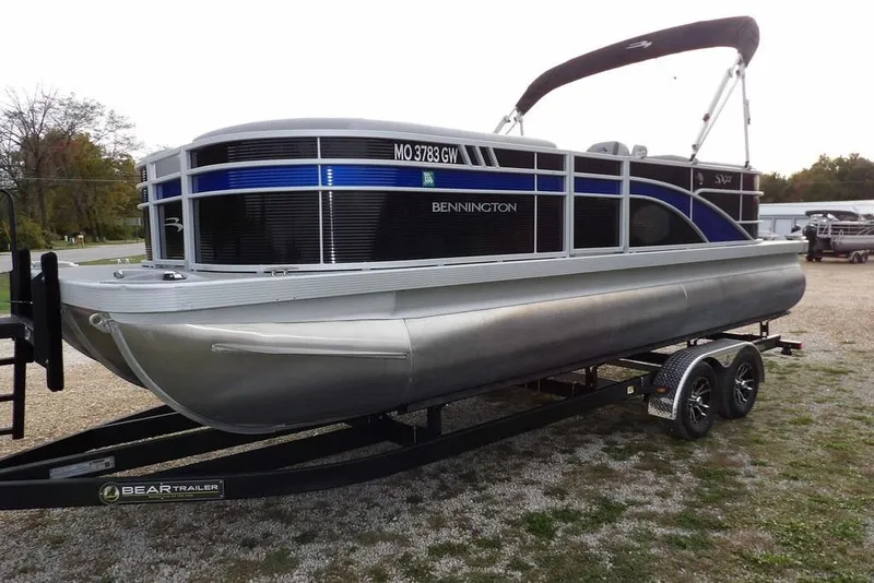Slide: The Image of 2024 Bennington 22 SXS pontoon boat on trailer, featuring sleek design and modern amenities. - 14