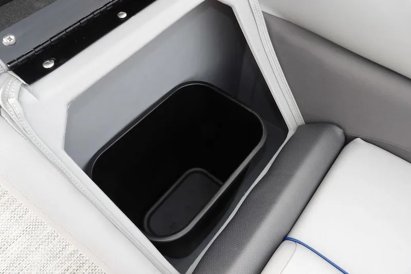 Slide: The Image of 2024 Bennington 22 SXS storage compartment with black interior bin. - 18