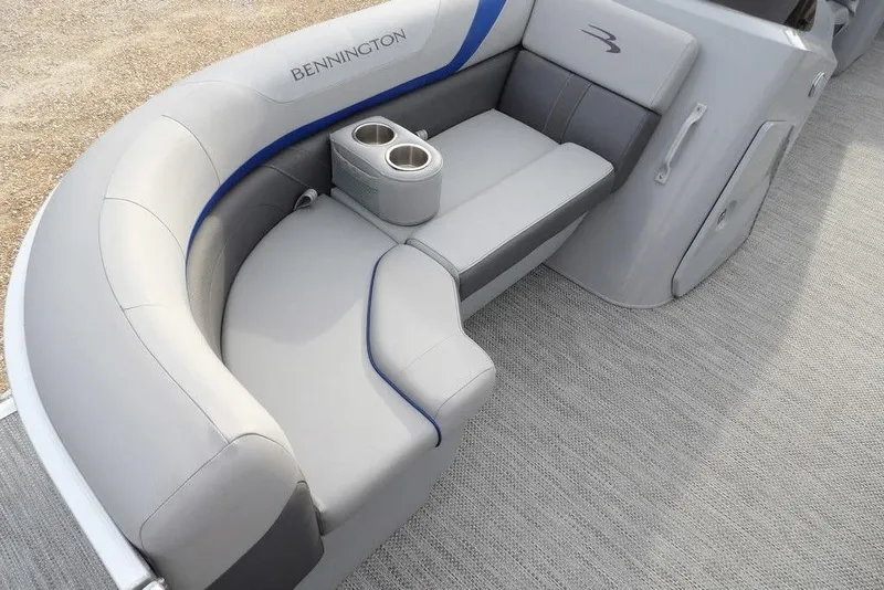 Slide: The Image of 2024 Bennington 22 SXS boat interior with gray seating and cup holders. - 19