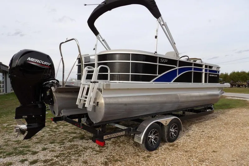 Slide: The Image of 2024 Bennington 22 SXS pontoon boat with Mercury outboard engine on trailer. - 21
