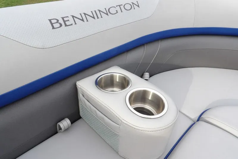 Slide: The Image of 2024 Bennington 22 SXS boat interior with cup holders and logo. - 22