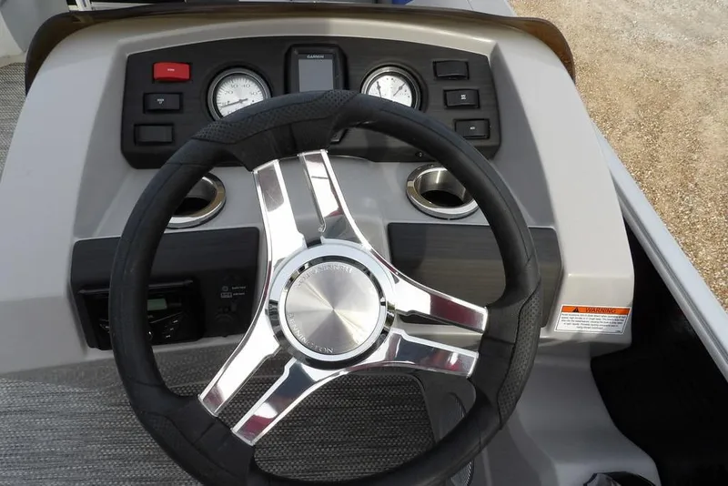 Slide: The Image of Steering wheel and dashboard of 2024 Bennington 22 SXS boat, featuring modern controls. - 23