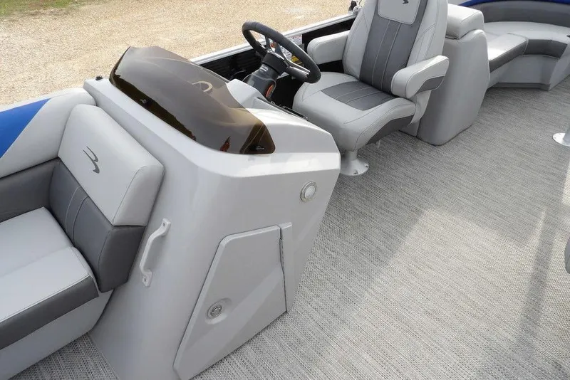 Slide: The Image of 2024 Bennington 22 SXS boat interior with modern seating and steering console. - 24