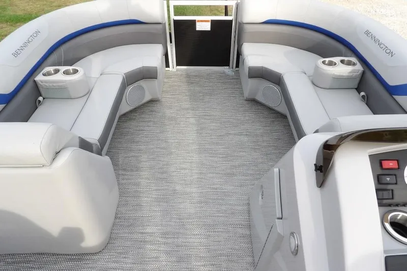 Slide: The Image of 2024 Bennington 22 SXS pontoon boat interior with plush seating and cup holders. - 25