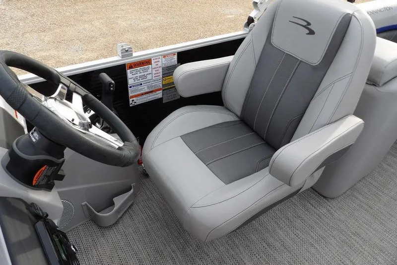 Slide: The Image of 2024 Bennington 22 SXS boat interior with steering wheel and captain's chair. - 33