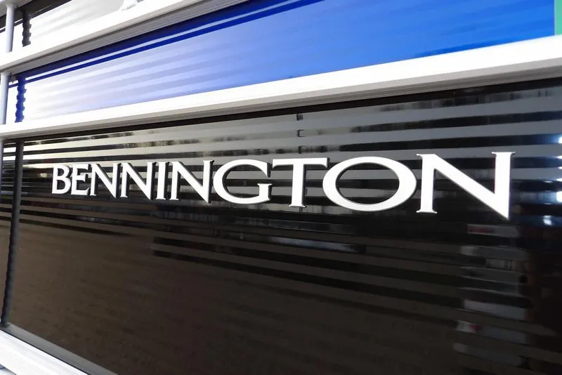 Slide: The Image of Bennington 22 SXS 2024 model logo on sleek black and blue surface. - 5