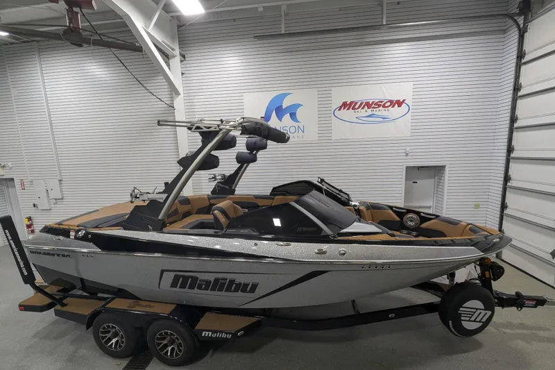 The Image of 2022 Malibu Wakesetter 22 LSV boat in showroom, featuring sleek design and modern features. - 1