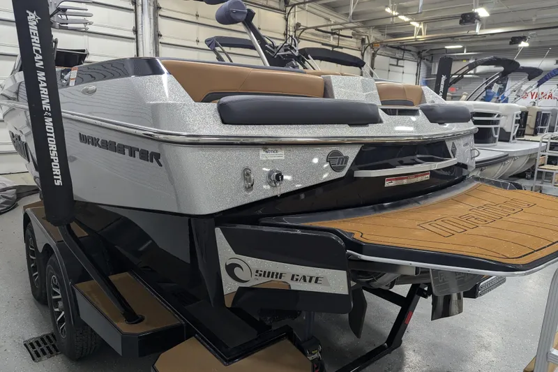 Slide: The Image of 2022 Malibu Wakesetter 22 LSV boat in showroom, featuring Surf Gate technology. - 10