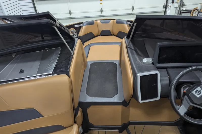 Slide: The Image of 2022 Malibu Wakesetter 22 LSV interior with tan and black seating, modern dashboard. - 14
