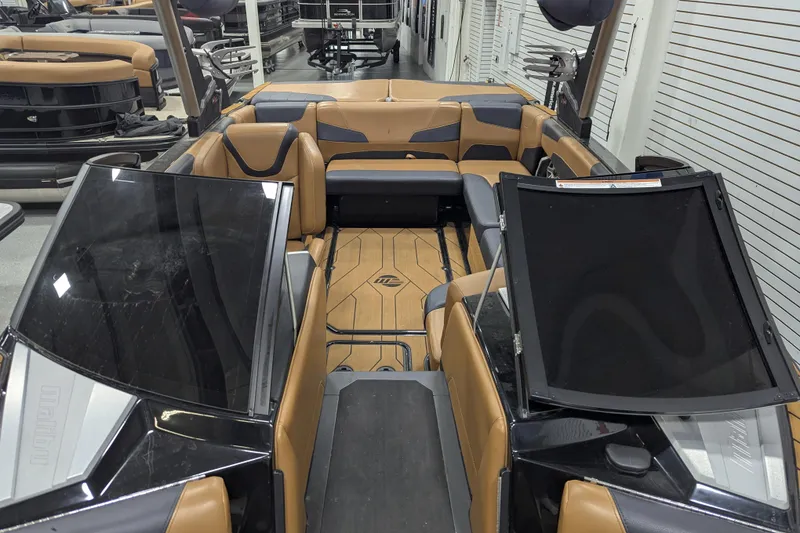 Slide: The Image of 2022 Malibu Wakesetter 22 LSV interior with tan and black seating, showroom display. - 16