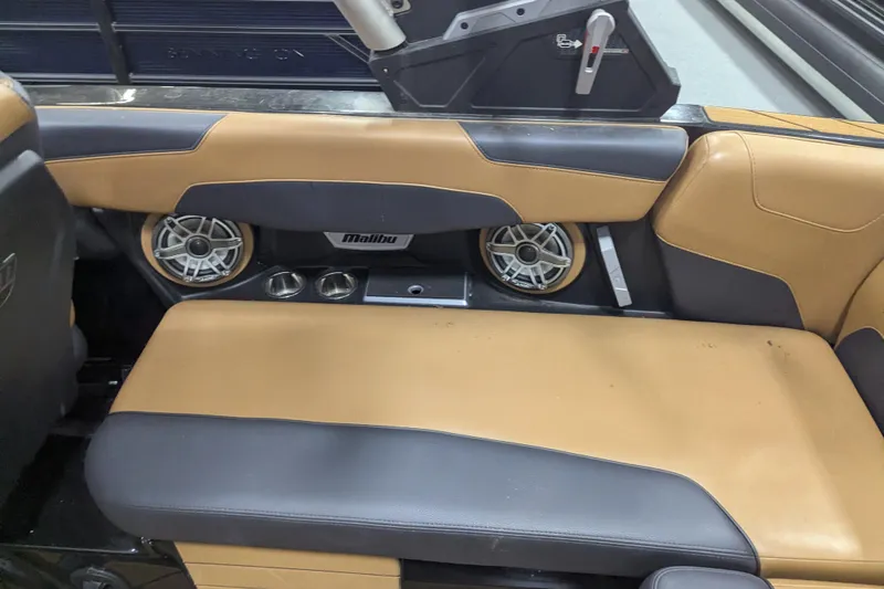 Slide: The Image of 2022 Malibu Wakesetter 22 LSV interior with tan and black seating, speakers, and cup holders. - 21