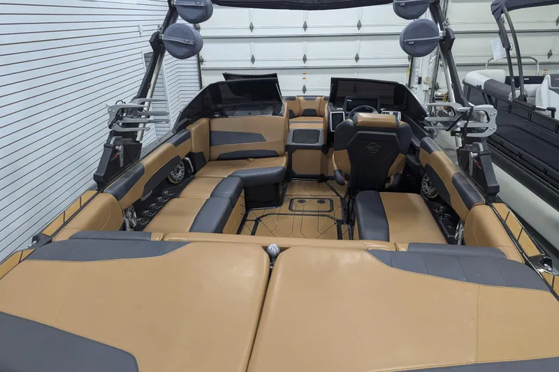 Slide: The Image of 2022 Malibu Wakesetter 22 LSV interior with tan and black seating, advanced dashboard, and spacious layout. - 25