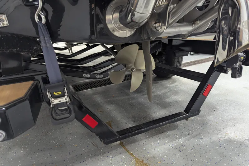 Slide: The Image of 2022 Malibu Wakesetter 22 LSV boat propeller and trailer detail in a garage. - 26
