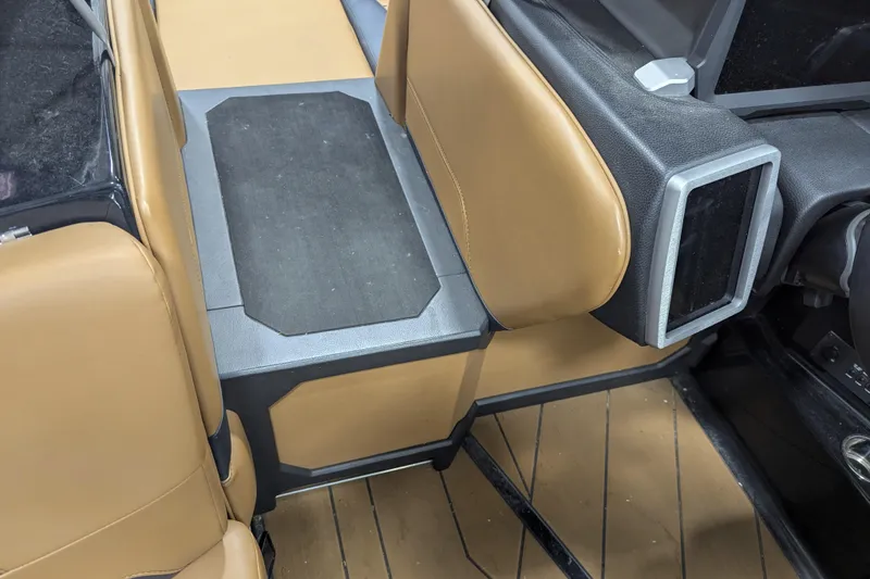 Slide: The Image of Interior of 2022 Malibu Wakesetter 22 LSV with tan and black seating. - 28