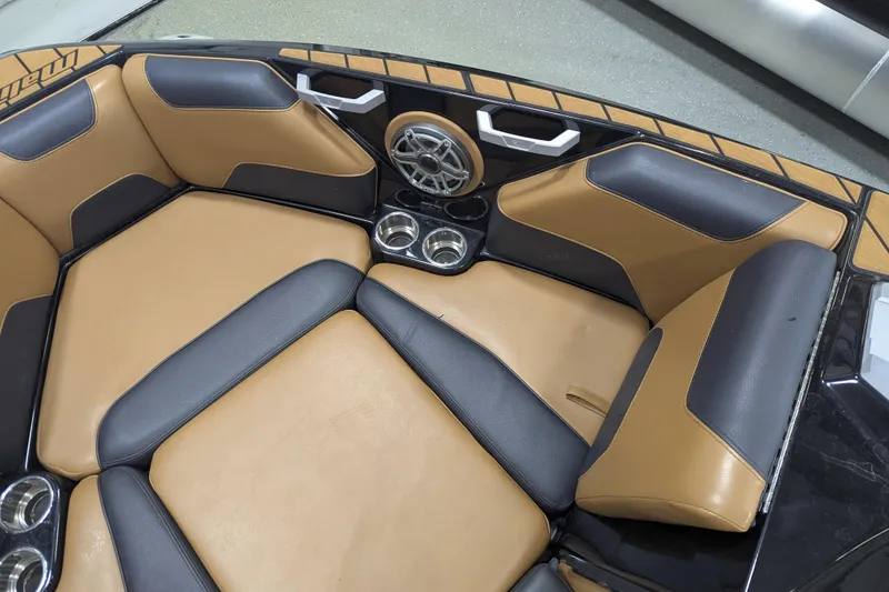 Slide: The Image of 2022 Malibu Wakesetter 22 LSV interior with tan and black seating, cup holders, and speaker. - 29