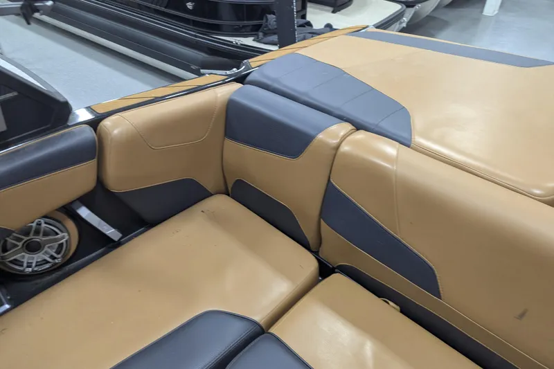 Slide: The Image of 2022 Malibu Wakesetter 22 LSV interior with tan and gray seating. - 31