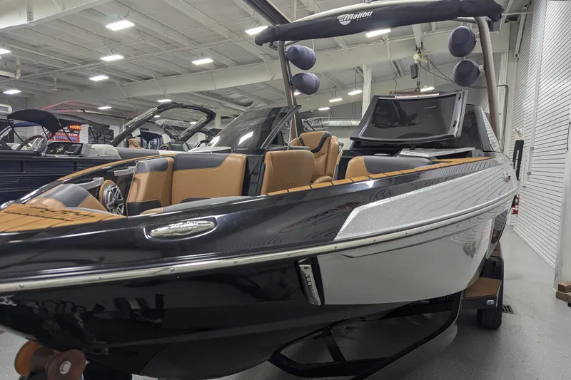 Slide: The Image of 2022 Malibu Wakesetter 22 LSV boat with sleek design and tan interior in showroom. - 8