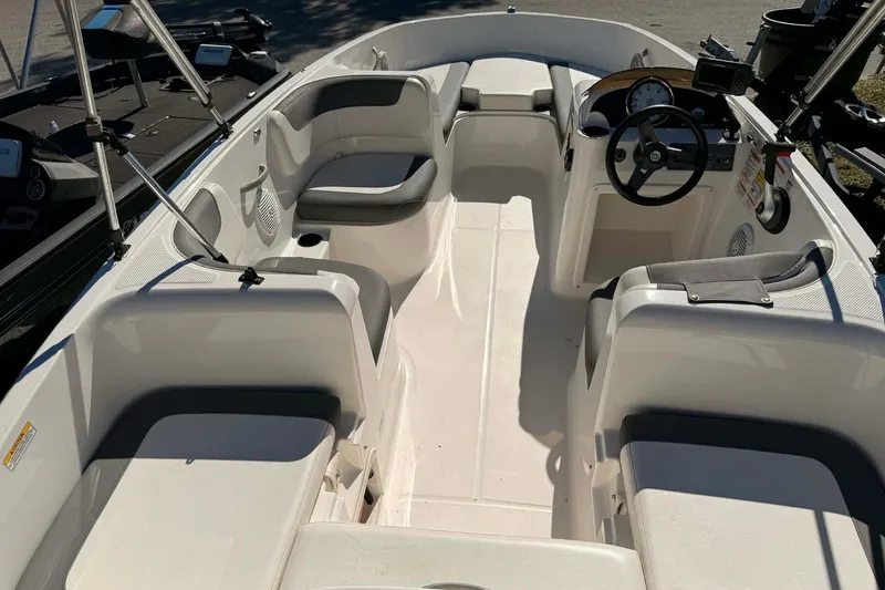 Slide: The Image of 2021 Bayliner Element E16 boat interior with seating and steering console. - 3
