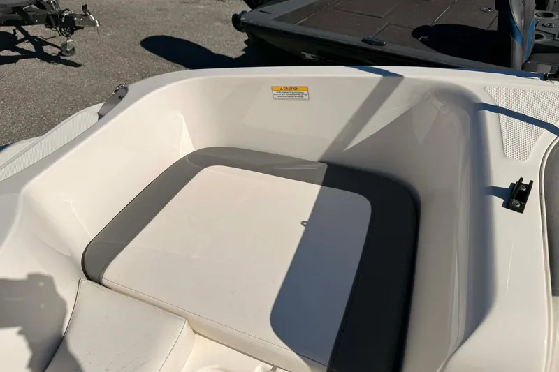 Slide: The Image of 2021 Bayliner Element E16 boat interior seating area in sunlight. - 4