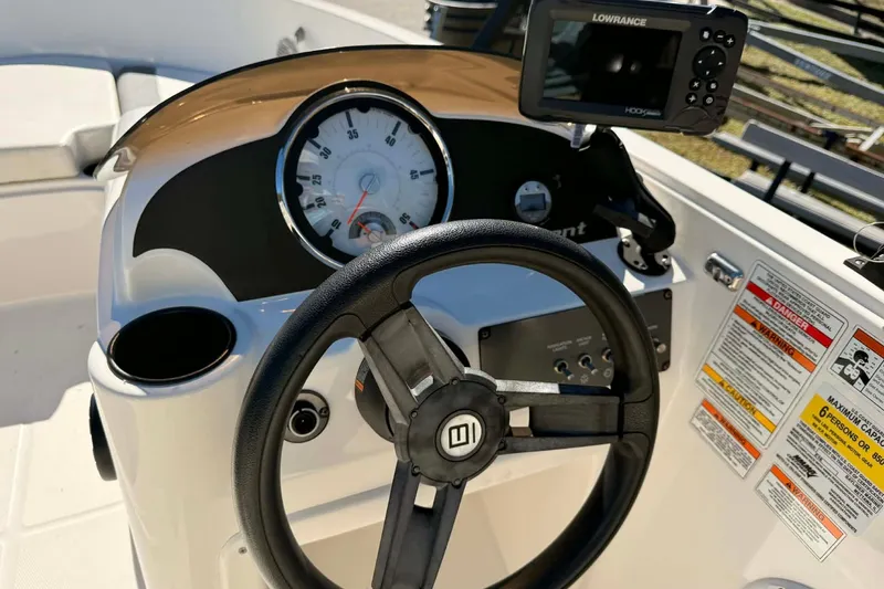Slide: The Image of 2021 Bayliner Element E16 dashboard with steering wheel and navigation system. - 9