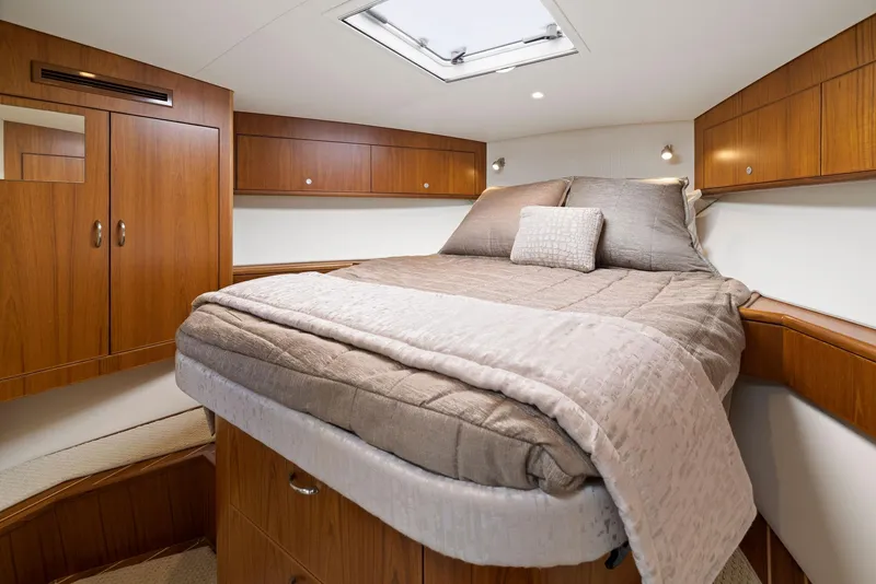 Slide: The Image of Luxurious cabin interior of 2012 Cabo 44 Hardtop Express yacht with cozy bed. - 13