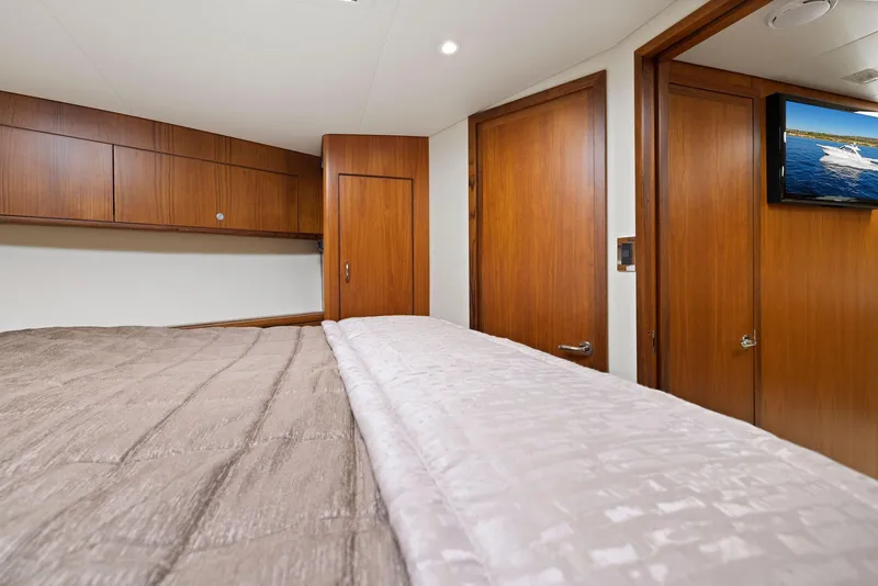 Slide: The Image of Luxurious cabin interior of 2012 Cabo 44 Hardtop Express yacht with wood finishes. - 17