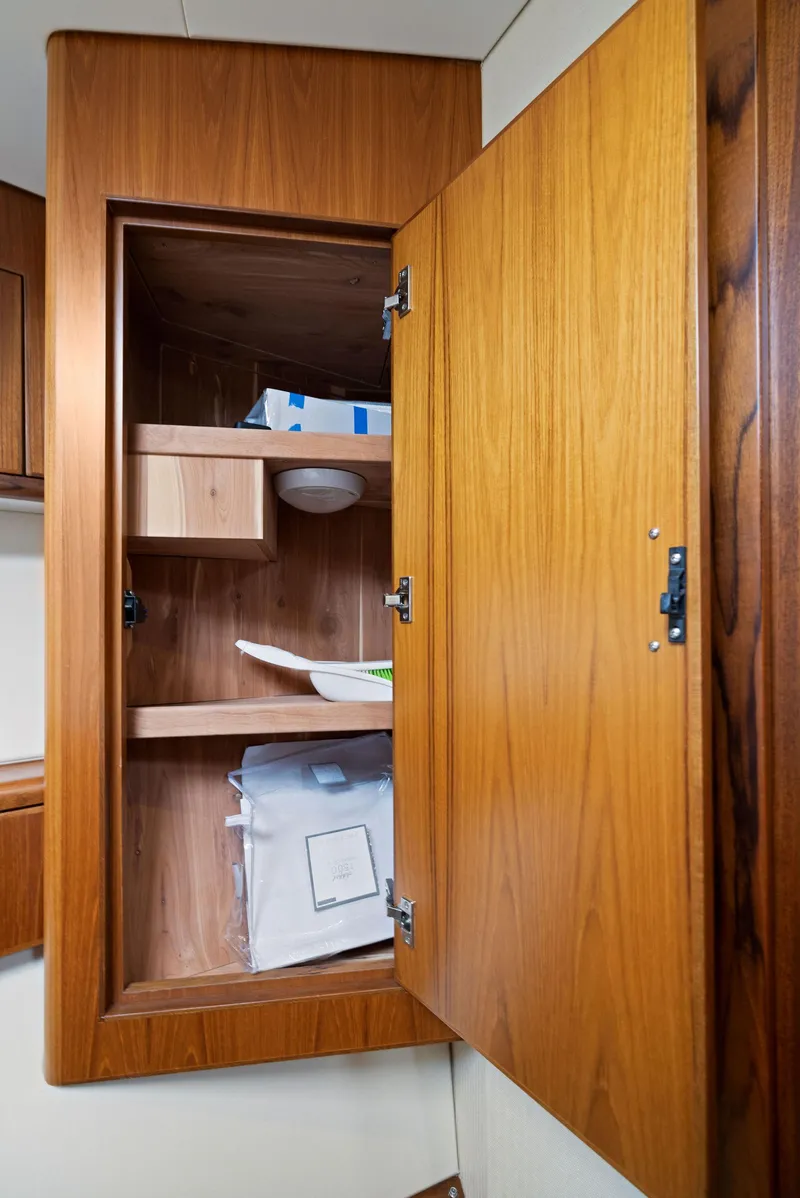 Slide: The Image of Open wooden cabinet in 2012 Cabo 44 Hardtop Express boat. - 19